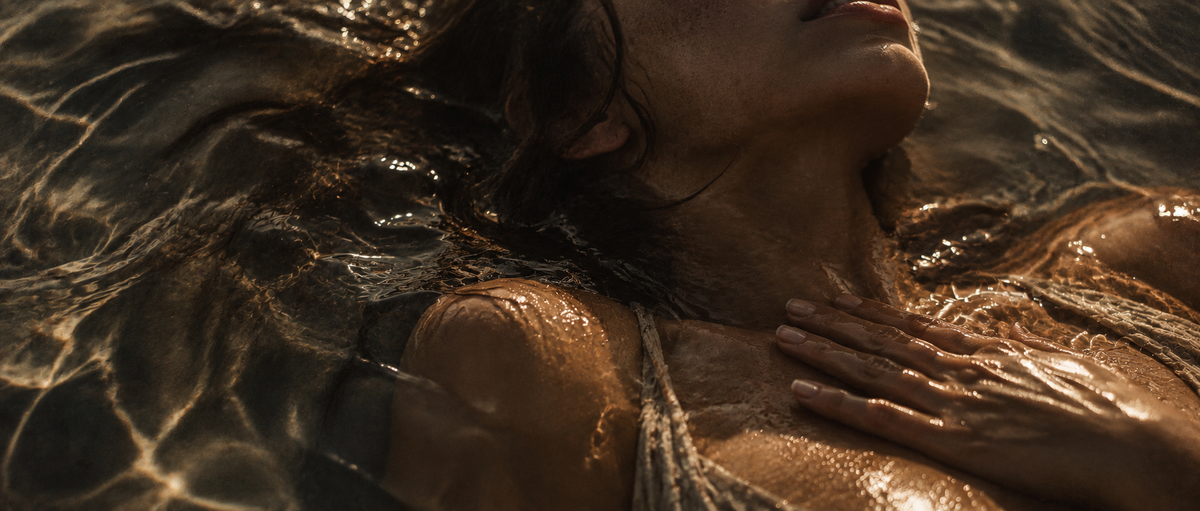 Woman resting in water with her hand over her heart, representing presence, body awareness and nervous system regulation at Apela Wellness in South Lake Tahoe